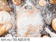 flour chopping board variety breads table. Стоковое фото, агентство Ingram Publishing / Фотобанк Лори