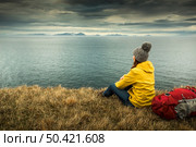 Female backpacker tourist in Icleand resting after a long day of adventures. Стоковое фото, агентство Ingram Publishing / Фотобанк Лори