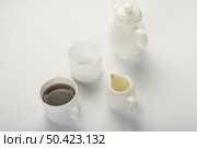 black tea milk jug white cup teapot isolated white backdrop. Стоковое фото, агентство Ingram Publishing / Фотобанк Лори