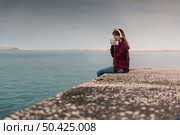 Beautiful woman enjoying her day in the lake with a mug of hot coffee. Стоковое фото, агентство Ingram Publishing / Фотобанк Лори