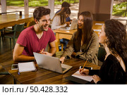 Group of friends studying together for finals. Стоковое фото, агентство Ingram Publishing / Фотобанк Лори