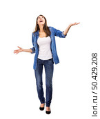 Happy woman trying to catch something falling from the sky. Стоковое фото, агентство Ingram Publishing / Фотобанк Лори