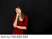 Beautiful young student thinking over a black chalkboard. Стоковое фото, агентство Ingram Publishing / Фотобанк Лори