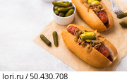 high angle delicious hot dogs with pickles. Стоковое фото, агентство Ingram Publishing / Фотобанк Лори