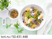 Herring and boiled potato salad with egg, capers and red onion. Top view. Стоковое фото, агентство Ingram Publishing / Фотобанк Лори