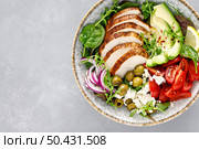 Grilled chicken breast and fresh vegetable salad with tomatoes, feta cheese, olives and avocado. Healthy food. Top view. Стоковое фото, агентство Ingram Publishing / Фотобанк Лори