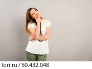 Beautiful and lovely girl making a thinking expression. Стоковое фото, агентство Ingram Publishing / Фотобанк Лори
