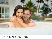 Young couple in a luxury hotel embraced inside a jacuzzi and enjoying the holidays. Стоковое фото, агентство Ingram Publishing / Фотобанк Лори