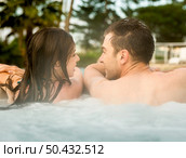 Young couple in a luxury hotel inside a jacuzzi enjoying the holidays. Стоковое фото, агентство Ingram Publishing / Фотобанк Лори