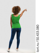 Beautiful African American woman pointing to somewhere. Стоковое фото, агентство Ingram Publishing / Фотобанк Лори