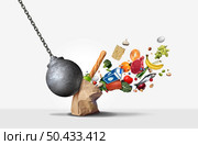 Food price inflation and rising grocery costs or prices surging for supermarket groceries as a financial crisis concept hit by a a wrecking ball with 3D render elements. Стоковое фото, агентство Ingram Publishing / Фотобанк Лори