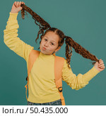 school girl with yellow shirt fooling around. Стоковое фото, агентство Ingram Publishing / Фотобанк Лори