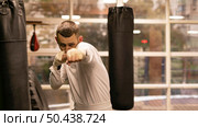 male boxer practicing with punching bags. Стоковое фото, агентство Ingram Publishing / Фотобанк Лори