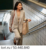 elegant young woman coming out metro station. Стоковое фото, агентство Ingram Publishing / Фотобанк Лори