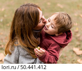 high angle woman kissing son. Стоковое фото, агентство Ingram Publishing / Фотобанк Лори