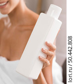 young beautiful woman holding bottle body lotion. Стоковое фото, агентство Ingram Publishing / Фотобанк Лори