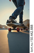 Low perspective shot of male feet in sneakers or skating shoes ride longboard and swerve on pavement. Cool extreme sport lifestyle or transportation mode. Стоковое AI-видео, аниматор Sergey Grishin / Фотобанк Лори
