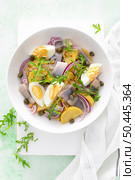 Herring and boiled potato salad with egg, capers and red onion. Top view. Стоковое фото, агентство Ingram Publishing / Фотобанк Лори
