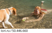 woman swimming playing with dog. Стоковое фото, агентство Ingram Publishing / Фотобанк Лори