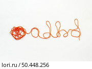 ADHD abbreviation formed of red tangled thread on white background. Attention deficit hyperactivity disorder and mental health awareness.. ADHD formed of tangled thread. Стоковое фото, агентство Ingram Publishing / Фотобанк Лори