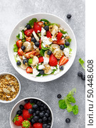 Fruit and berry salad with fresh strawberry, blueberry, banana, cottage cheese and granola with almond. Healthy food, diet breakfast. Стоковое фото, агентство Ingram Publishing / Фотобанк Лори