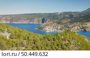 Village of Assos nestled between forested hills and twin bays in Kefalonia Greece. Стоковое видео, видеограф Igor Tichonow / Фотобанк Лори