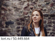 Dreamy Gaze Towards Future Possibilities Against a Stone Wall in Old Town. Стоковое фото, фотограф Aleksandr Golubev / Фотобанк Лори
