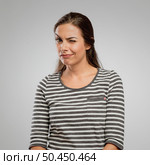 Portrait of a beautiful happy winking, over a gray background. Стоковое фото, агентство Ingram Publishing / Фотобанк Лори