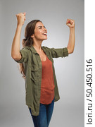Beautiful and successful young woman with arms raised. Стоковое фото, агентство Ingram Publishing / Фотобанк Лори