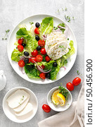 Salad with mozzarella cheese, cherry tomato, olives and romain lettuce, top view. Стоковое фото, агентство Ingram Publishing / Фотобанк Лори