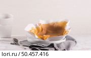 Portuguese sponge cake wrapped in the typical paper used on the baking, on marble background. Стоковое фото, агентство Ingram Publishing / Фотобанк Лори