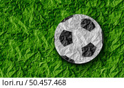 Football Soccer Background and sport as a grass sports field with a european game football on a green paper turf . Стоковое фото, агентство Ingram Publishing / Фотобанк Лори