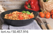 Italian Pasta with Tuna and Basil. Fresh pasta with tuna and tomato sauce on old wooden background. Стоковое фото, агентство Ingram Publishing / Фотобанк Лори
