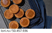 Caramel cookies flowing out of the oven, in the kitchen after baking. Стоковое фото, агентство Ingram Publishing / Фотобанк Лори