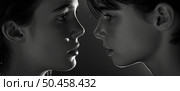 Two youths are captured in a moment of silent communication, faces nearly touching, surrounded by shadows. Стоковое AI-изображение, AI-художник Данила Большаков / Фотобанк Лори