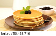 Delicious golden pancakes with fresh blackberries and raspberry jam. Стоковое фото, агентство Ingram Publishing / Фотобанк Лори