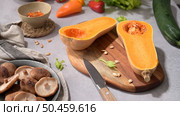 Autumn vegetables arranged on a kitchen worktop while preparing a pumpkin soup. Стоковое фото, агентство Ingram Publishing / Фотобанк Лори