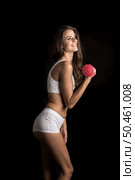 Portrait of young beautiful woman making physical exercises with dumbbells. Стоковое фото, агентство Ingram Publishing / Фотобанк Лори