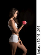 Portrait of young beautiful woman making physical exercises with dumbbells. Стоковое фото, агентство Ingram Publishing / Фотобанк Лори