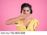 Young woman covering her mouth showing shut up. Стоковое фото, агентство Ingram Publishing / Фотобанк Лори