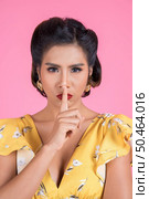 Beauty asian woman red lips and finger showing hush silence sign. Стоковое фото, агентство Ingram Publishing / Фотобанк Лори