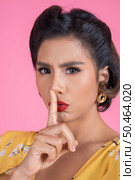 Beauty asian woman red lips and finger showing hush silence sign. Стоковое фото, агентство Ingram Publishing / Фотобанк Лори