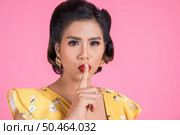 Beauty asian woman red lips and finger showing hush silence sign. Стоковое фото, агентство Ingram Publishing / Фотобанк Лори