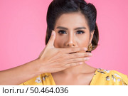 Young woman covering her mouth showing shut up. Стоковое фото, агентство Ingram Publishing / Фотобанк Лори