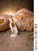 Rustic bread and wheat on an old vintage planked wood table. Стоковое фото, агентство Ingram Publishing / Фотобанк Лори