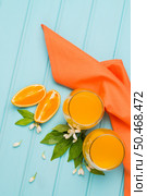 Freshly squeezed orange juice on wood background. Стоковое фото, агентство Ingram Publishing / Фотобанк Лори