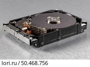 Open computer hard disk drive (HDD) closeup. Стоковое фото, агентство Ingram Publishing / Фотобанк Лори