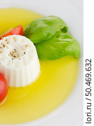 Fresh salad with goat cheese, tomato and basil pesto on a white plate. Стоковое фото, агентство Ingram Publishing / Фотобанк Лори