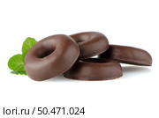 Chocolate donut cookies with green mint leaves on whute background. Стоковое фото, агентство Ingram Publishing / Фотобанк Лори