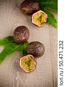 Passion fruits on wooden background. Стоковое фото, агентство Ingram Publishing / Фотобанк Лори